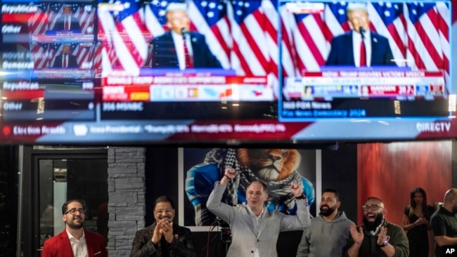 FILE - People cheer as Republican presidential nominee former President Donald Trump's speech is broadcast during an Arab Americans for Trump watch party at the Lava Java Cafe, a hookah lounge, in Dearborn, Michigan, Nov. 6, 2024.