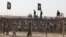 In this December 9, 2011, photo provided by the People's Mujahedeen Organization of Iran via AP, Iraqi police stand guard outside Camp Ashraf northeast of Baghdad (image authenticity cannot be independently verified). 