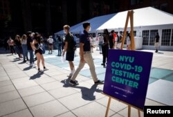 Students wait in line at a testing site for the COVID-19 set up for returning students, faculty and staff on the main campus of New York University (NYU) in Manhattan in New York City, Aug. 18, 2020.