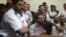 Friends of Egyptian suspects react as they listen to the judge's verdict at a court room during a case against foreign non-governmental organizations (NGOs) in Cairo, June 4, 2013