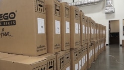 Boxes of bikes from Vietnam are stacked in the warehouse of Pedego Electric Bikes in Fountain Valley, California. The bikes are assembled at the company's headquarters. (VOA/E. Lee)