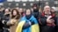 Supporters of Ukrainian EU integration sing and wave flags during a protest in front of the Ukrainian cabinet of ministers building in Kiev December 6, 2013. Ukrainian pro-Europe demonstrators vowed to stay on the streets and continue their blockade of go