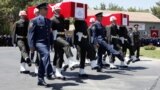 Turkish soldiers carry the coffins of fallen Turkish pilots, Captain Gokhan Ertan and Lieutenant Hasan Huseyin Aksoy, during an official farewell ceremony at the 7th Jet Main Air Base in the eastern Turkish city of Malatya July 6, 2012.