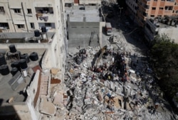 A general view as rescue workers search for victims amid rubble at the site of Israeli airstrikes, in Gaza City May 16, 2021.