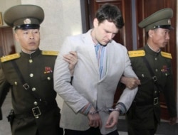 FILE - American student Otto Warmbier is escorted at the Supreme Court in Pyongyang, North Korea, March 16, 2016. Warmbier was sentenced to 15 years in prison with hard labor.