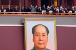 Chinese President Xi Jinping, center, waves above a large portrait of the late leader Mao Zedong during a ceremony to mark the 100th anniversary of the founding of the ruling Chinese Communist Party at Tiananmen Gate in Beijing Thursday, July 1,…