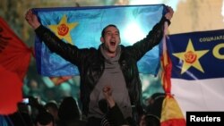 Supporters of the opposition Social Democratic Union of Macedonia (SDSM) celebrate during parliamentary elections in Skopje, Macedonia, Dec. 11, 2016.