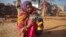 FILE - A 14-year-old girl sits with her four-month-old baby in a village in the northwestern India, January 21, 2013. The girl married her husband when she was 11 and he was 13.