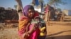 FILE - A 14-year-old girl sits with her four-month-old baby in a village in the northwestern India, January 21, 2013. The girl married her husband when she was 11 and he was 13. 