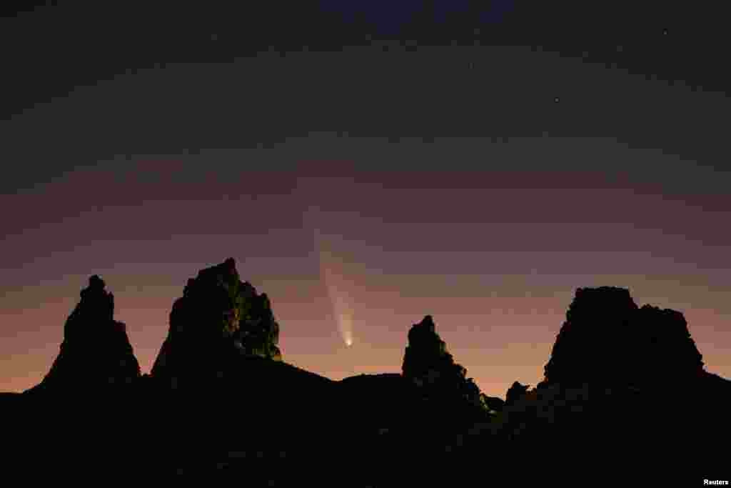 Comet Tsuchinshan-ATLAS, C/2023, with an 80,000 year orbit, passes behind geological formations, tufa spires at Trona Pinnacles, California, Oct. 12, 2024. 