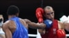 Eldric Sella Rodríguez (rojo) del Equipo Olímpico de Refugiados y Euri Cedeno Martínez de la República Dominicana pelean durante el combate de boxeo preliminar de peso medio masculino (69-75 kg) durante los Juegos Olímpicos de Tokio 2020 en el Kokugikan A