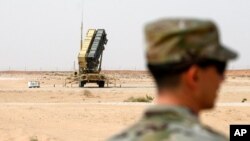 FILE - A member of the U.S. Air Force stands near a Patriot missile battery at the Prince Sultan air base in al-Kharj, central Saudi Arabia, Feb. 20, 2020.