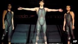 FILE - In this Feb. 12, 2008, file photo, American Olympic medalists Amanda Beard, left, Natalie Coughlin, right, and Michael Phelps pose in new, high technology Speedo "LZR Racer" swimsuits they will wear during the Beijing Summer Olympics.