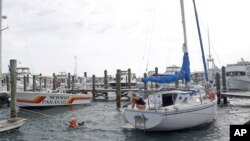 Craig Jones, left, and Kimberly Branson secure their boat in Key West, Fla., in preparation for Tropical Storm Isaac, August 26, 2012. 