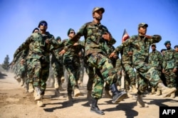 FILE - Afghan National Army soldiers march during a ceremony at a military base in the Guzara district of Herat province, Oct. 11, 2020. (AFP)