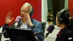 Malaysian Prime Minister Najib Razak, left, gestures as he speaks at a radio station in Kuala Lumpur, Malaysia, September 20, 2011.