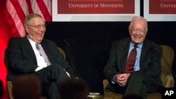 Former President Jimmy Carter participate in a tribute to former Vice President Walter Mondale, left, in Washington, Oct. 20, 2015. 