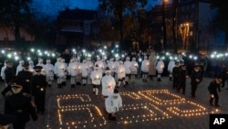 Cadets light candles arranged into the shape of "659," the number of Ukrainian children killed in the war with Russia, in a military lyceum on World Children's Day in Kyiv, Ukraine, Nov. 20, 2024. Meanwhile, Russian theories falsely accuse Ukraine of child organ harvesting.