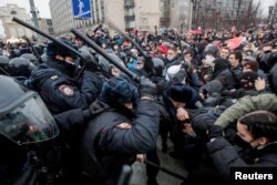 FILE - Law enforcement officers clash with participants during a rally in support of jailed Russian opposition politician Alexei Navalny in Moscow, Russia, Jan. 23, 2021.