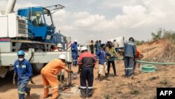 Rescue workers install a pump to drain water from a collapsed mineshaft at Ran Mine, in Bindura, Zimbabwe, Nov. 26, 2020.