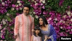 FILE - Indian film actor Abhishek Bachchan, his wife Aishwarya Rai and their daughter Aaradhya in a March 9, 2019 photograph taken at the wedding of Akash Ambani, the son of Reliance Industries chairman Mukesh Ambani, in Mumbai, India. 