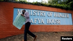 FILE - A Kenyan talks on his mobile phone outside the Ministry of Health headquarters in Nairobi, Kenya, Dec. 8, 2016. On Nov. 21 and 22, 2019, Kenya held its first mental health conference, steered by its Ministry of Health.