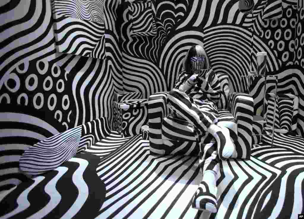 Model feebee poses as part of art installation &ldquo;Dazzle Room&rdquo; by artist Shigeki Matsuyama at Room 32 fashion and design exhibition in Tokyo. The installation features a strong contrast of black and white, which Matsuyama learned from dazzle camouflage used mainly in World War I.