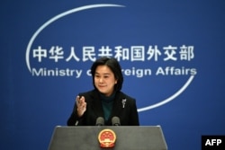 FILE - Chinese Foreign Ministry spokesperson Hua Chunying gestures during the daily Press conference at the Foreign Ministry in Beijing, Feb. 24, 2022.