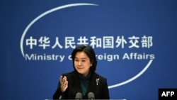 FILE - Chinese Foreign Ministry spokesperson Hua Chunying gestures during the daily Press conference at the Foreign Ministry in Beijing, Feb. 24, 2022. 
