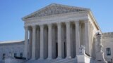 Visitors walk outside the Supreme Court building in Washington, Feb. 21, 2022.