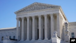 Visitors walk outside the Supreme Court building in Washington, Feb. 21, 2022.