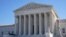 Visitors walk outside the Supreme Court building in Washington, Feb. 21, 2022.