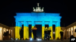 The Brandenburg Gate in Berlin, Germany, is illuminated in the colors of the Ukrainian flag to show solidarity with the country as Russia launches a military operation, Feb. 23, 2022.