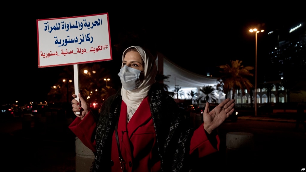 Mashael al-Shuwaihan, who sits on the board of Kuwait's Women's Cultural Society, speaks during an interview, at a protest outside Kuwait's National Assembly, in Kuwait City, Monday, Feb. 7, 2022. (AP Photo/Maya Alleruzzo)