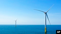 FILE - Part of the offshore wind farm that has been built off the coast of Virginia Beach, Virginia on June 29, 2020. (AP Photo/Steve Helber, File)