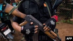 This photo taken on October 19, 2021 shows members of the Karenni Nationalities Defense Force and Kareni Army at a checkpoint near Demoso, in Myanmar's eastern Kayah state.