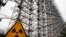 FILE - A Soviet-era top secret object Duga, an over-the-horizon radar system once used as part of the Soviet missile defense early-warning radar network, is seen behind a radioactivity sign in Chernobyl, Ukraine, on Nov. 22, 2018. 