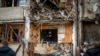 A man inspects the damage at a building following a rocket attack on the city of Kyiv, Ukraine, Feb. 25, 2022.