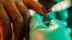 Elections Officer Applies Indelible Ink to Voter