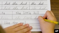 FILE - Students practice printing and cursive handwriting at the Mountaineer Montessori School in Charleston, WV., Sept. 2009. (AP Photo/Bob Bird)