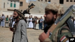 FILE - Armed Houthi fighters attend the funeral procession of Houthi rebel fighters who were killed in recent fighting with forces of Yemen's internationally recognized government, in Sanaa, Yemen, on Nov. 24, 2021. 