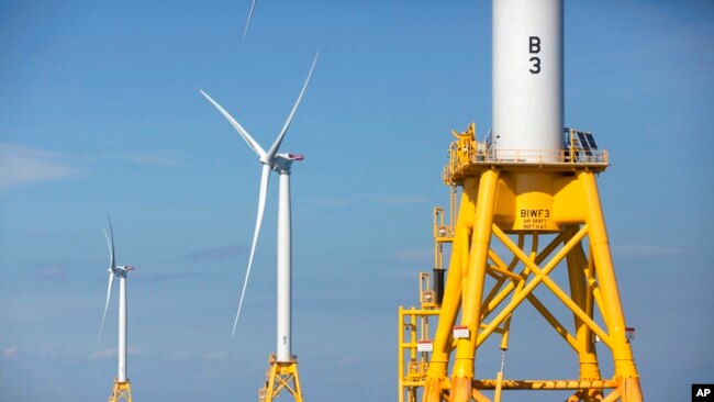 FILE - Three of Deepwater Wind's five turbines, a kind of engine, stand in the water off Block Island, Rhode Island on August 15, 2016. It is the United States' first offshore wind farm. (AP Photo/Michael Dwyer, File)