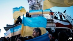 Demonstrators gather in support of the Ukrainian people, in Paris, Feb. 24, 2022. 