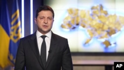 In this handout photo provided by the Ukrainian Presidential Press Office, Ukrainian President Volodymyr Zelenskyy addresses the nation.
