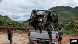 FILE - Members of the Karenni Nationalities Defence Force and Kareni Army at a checkpoint near Demoso, in Myanmar's eastern Kayah state, Oct. 19, 2021.