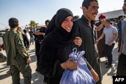 A man, suspected of having collaborated with the Islamic State (IS) group, is greeted by a family member upon his release from the Kurdish-run Alaya prison in the northeastern Syrian city of Qamishli, on Oct. 15, 2020.