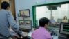 VOD Roundtable producers do final audio and video checks before going live with host Lim Thida, far right, and guest Yi Soksan of Adhoc, at VOD's studio, in Phnom Penh, Sept. 11, 2019. (Tum Malis/VOA Khmer)