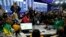 FILE— A ANC representative, left, looks on on the results board at the Results Operation Centre (ROC) in Midrand, Johannesburg, South Africa, June 1, 2024. 