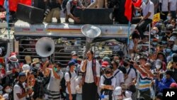 FILE - Demonstrators gather in an intersection close to Sule Pagoda to protest the military coup in Yangon, Myanmar, Feb. 17, 2021. 