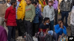 Indian daily wage laborers wait to get hired in Mumbai, Feb. 1, 2022. Indian Prime Minister Narendra Modi's government announced a series of investments to shore up spending in infrastructure projects in its annual budget, just days ahead of key state ele